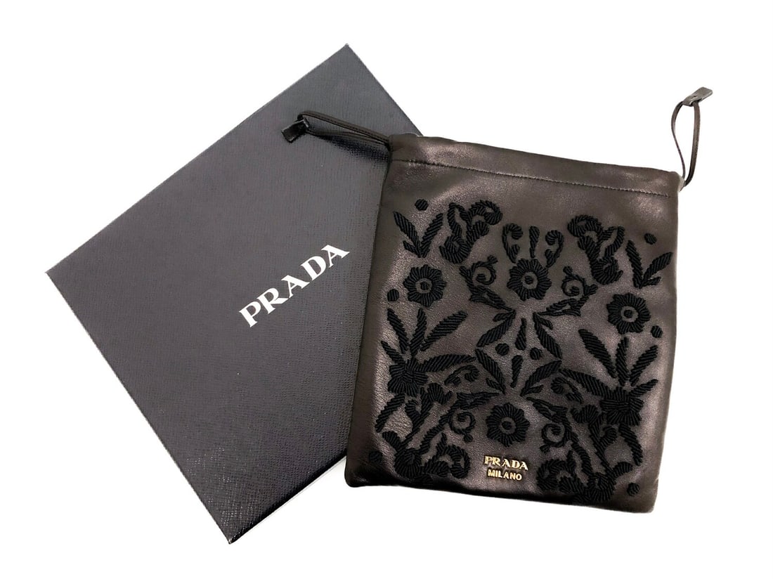 Exquisite Prada Black Embroidered Leather Pouch Gold Hardware: Exquisite Prada flat pouch featuring intricate embroidery on fine black leather and fabric. Enhanced by radiant gold hardware, this accessory showcases the brand?s dedication to artistic craftsmanship