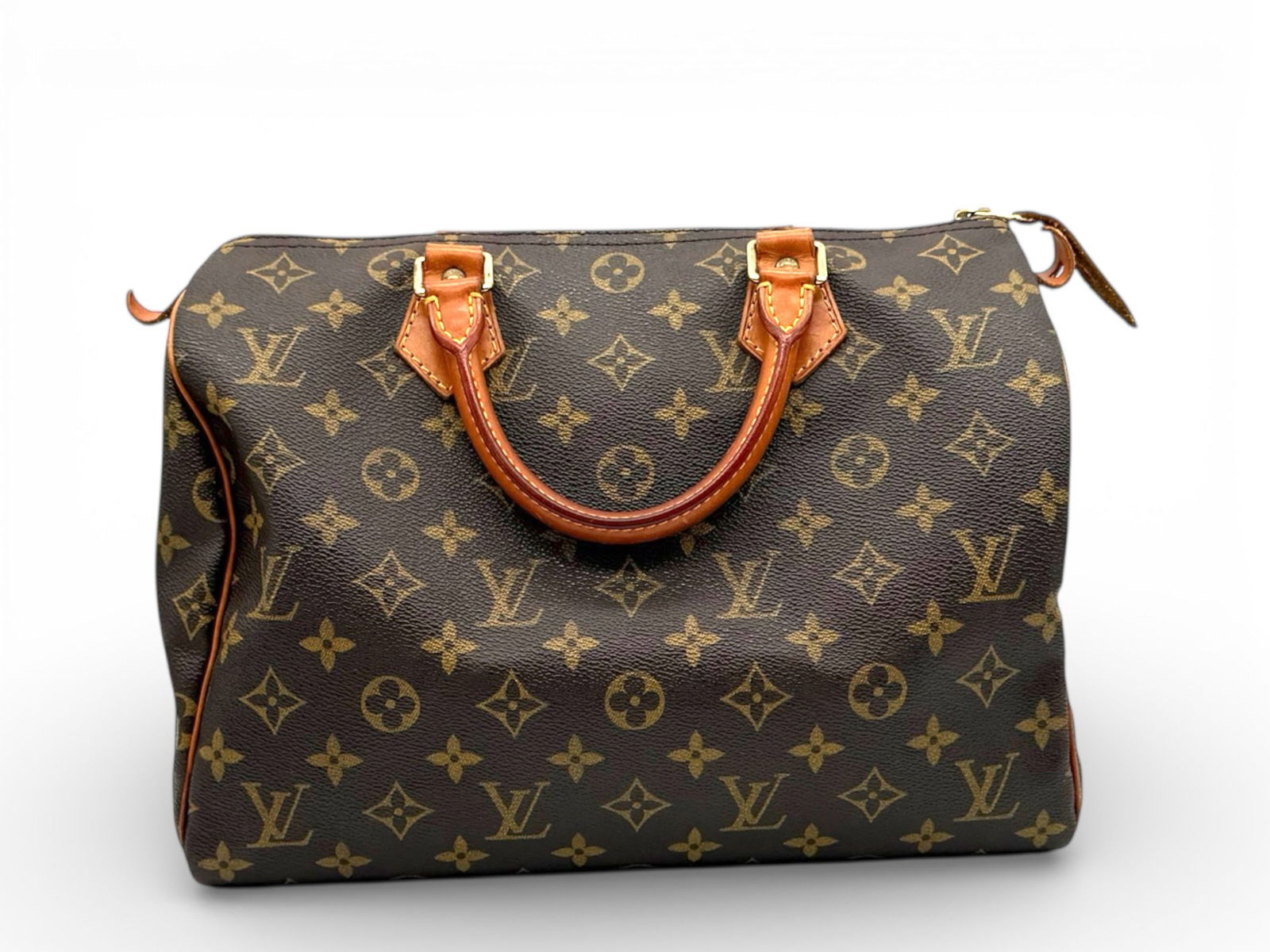 Speedy 30 by Louis Vuitton - Timeless Iconic Allure in Radiant Monogram Canvas: An enduring symbol of Parisian elegance, the Speedy 30 by Louis Vuitton captures refined sophistication in its instantly recognizable Monogram canvas. Graceful lines, luminous golden hardware, and nat
