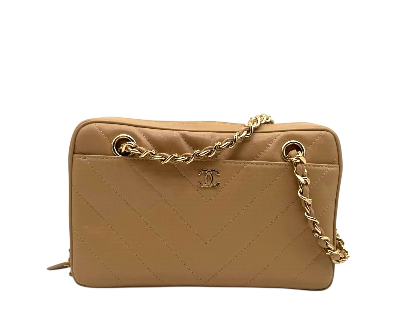 Chanel Camera Bag Chevron Luxurious Lambskin in Soft Beige with Gold Hardware: Elevate your elegance with the Chanel Camera Bag Chevron, crafted in sumptuous lambskin that exudes timeless sophistication and style. Brand: Chanel Type: Shoulder Bag Material: Lambskin Color: Beige
