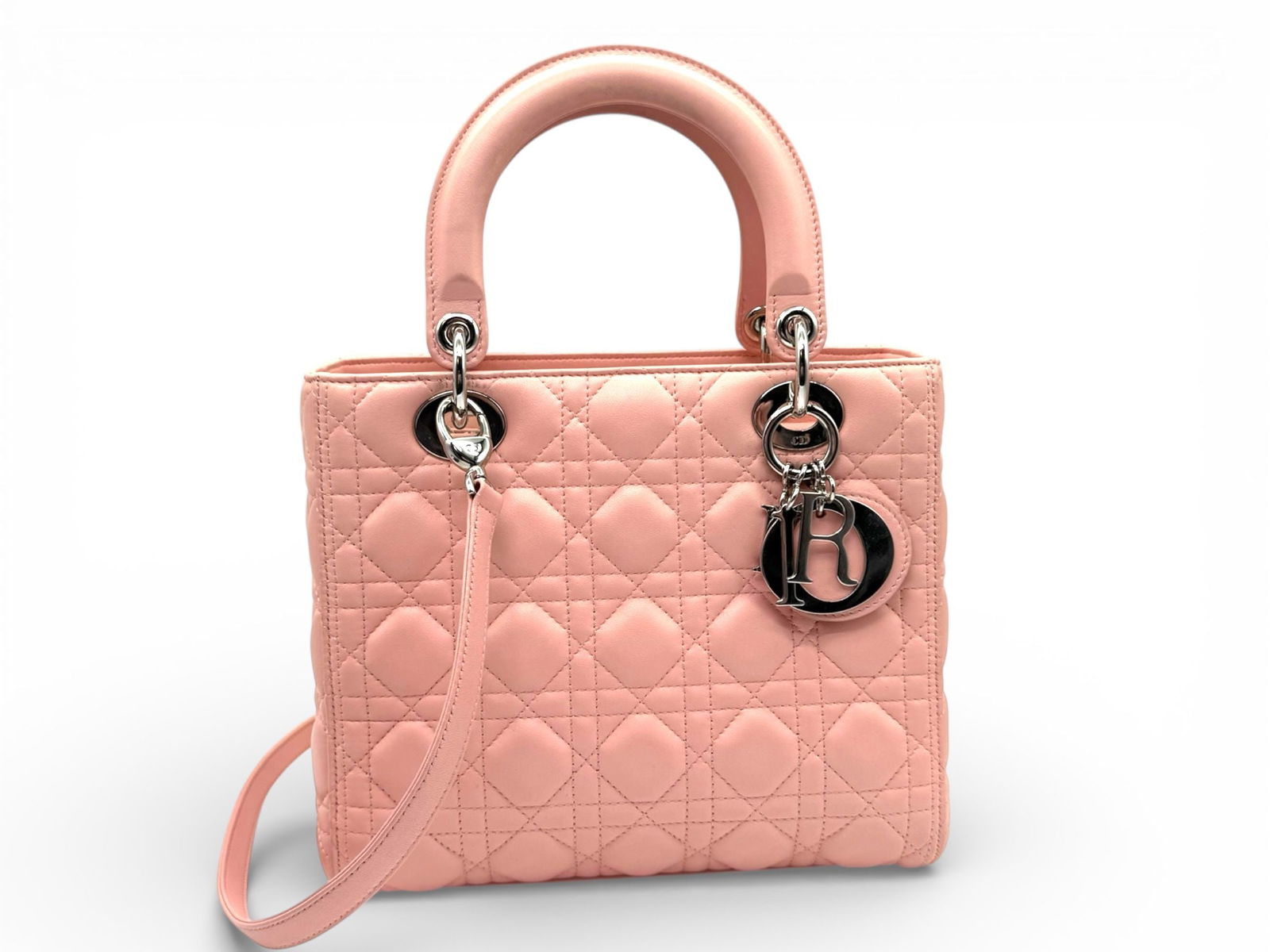 Dior Lady Dior Medium Elegant Lambskin Shoulder Bag in Soft Pink with Silver Hardware: Embrace feminine elegance with the Dior Lady Dior Medium, a luxurious lambskin bag that exudes sophistication and timeless charm. Brand: Dior Type: Shoulder Bag / Crossbody Bag Material: Lambskin Colo