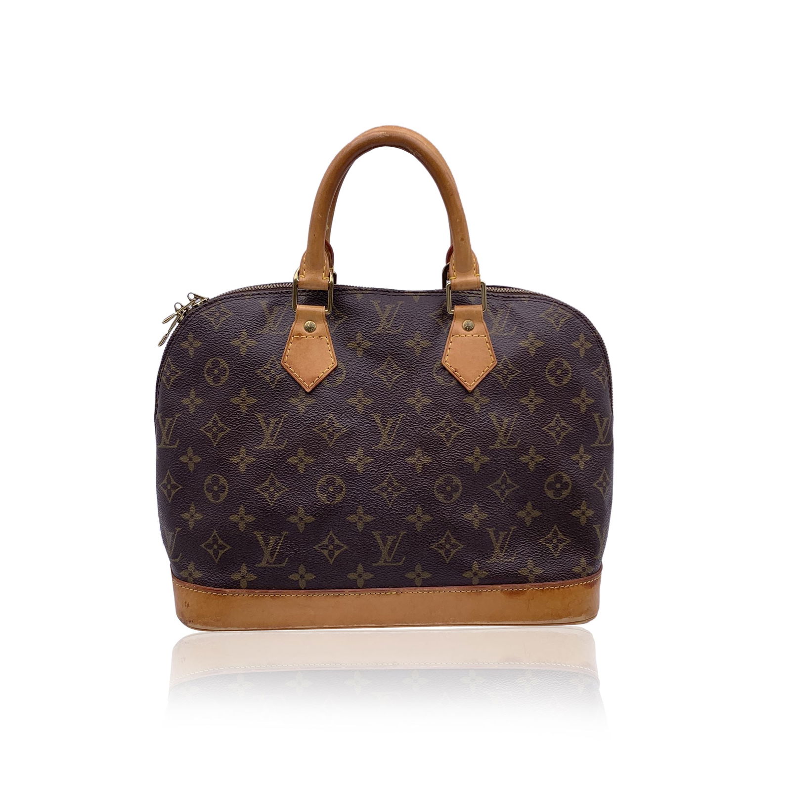 Louis Vuitton Vintage Cloth Handbag Alma: A Timeless Icon: The Louis Vuitton 'Alma' in Monogram Canvas There are bags-and then there are icons. The Alma by Louis Vuitton belongs to the latter. Inspired by a silhouette first dreamed up in the