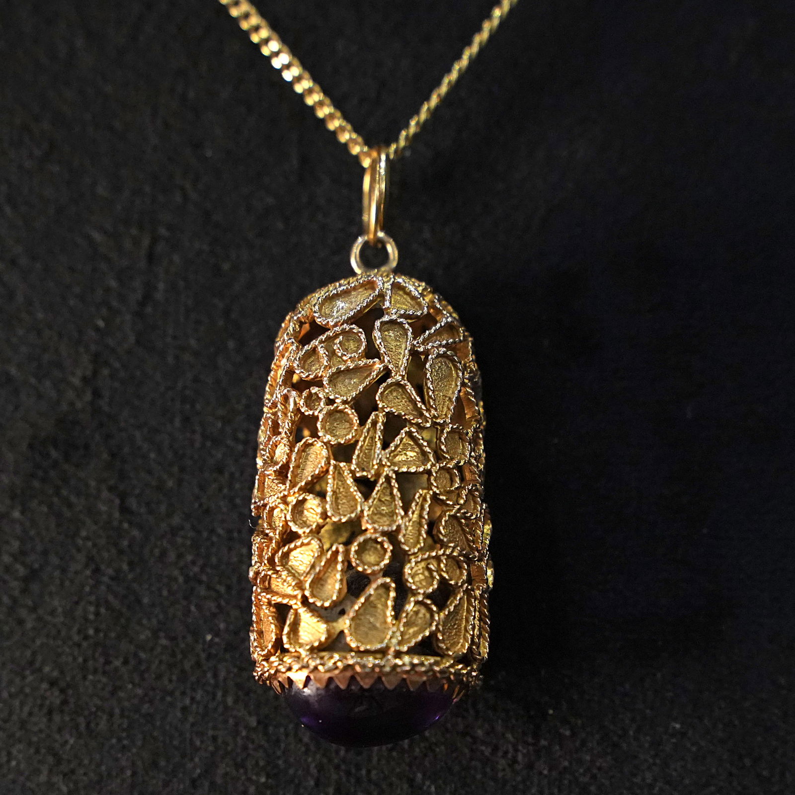 Stunning Antique18kt Yellow Gold Filigree Lantern Inspired Pendant with Amethyst Cabochon, 13.25gr: Stunning Antique 18kt yellow gold filigree lantern inspired pendant showcasing a cylindrical, domed structure with intricate openwork patterns, highlighting delicate organic motifs and a play of light