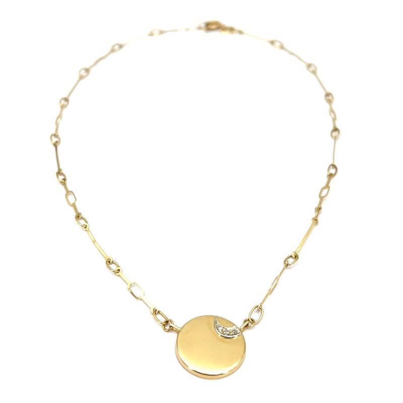 Yellow gold button pendant necklace and moon brilliants; 4.9 gr.: Circular button pendant necklace (1.75 cm in diameter), made of 18 kt yellow gold sheet and stylized diamond half moon. Light, fine, bright and beautiful!!! Our company's certification is available fo