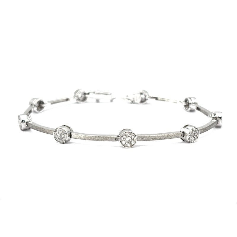 White gold tennis bracelet and cubic zirconia hoops; 12.22 gr - 18 cm: A beautiful 18 kt white gold tennis outlet bracelet, featuring a simple bar design with thick cubic zirconia beads. Solid, dramatic and super feminine! Our company's certification is available for fre