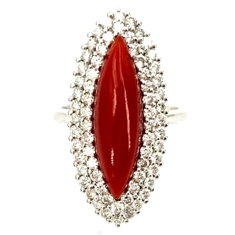 Coral, brilliants and white gold spool ring; 8.68 gr.: Sophisticated, intense and precious spool ring of natural cabochon coral protagonist, with double round of diamonds around the gemstone, 18 kt white gold setting. Admirable and pricelessly beautiful!