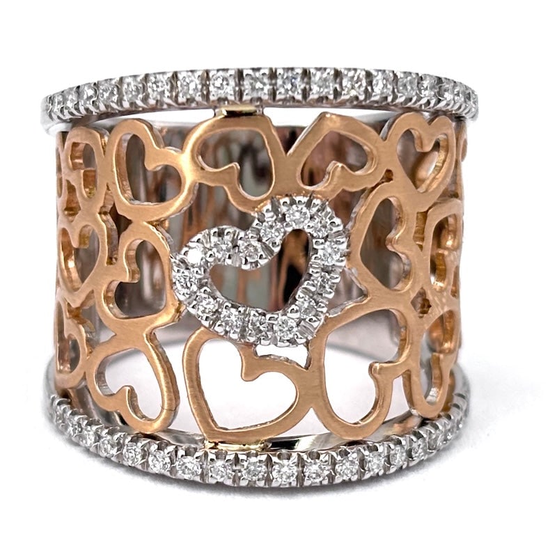Rose and white gold hearts and brilliants openwork band ring; 12.44 gr.: Stunning maxi band ring with pierced hearts in 18 kt rose gold with brilliants mounted on white gold double track and central heart. Superlative, luminous, vexatious universal and super fashionable! O