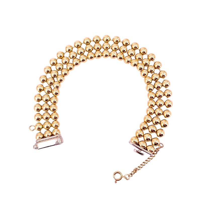 Yellow gold 3-row ball cuff bracelet; 33 gr; 19 cm: An exclusive three-row ball cuff totally in 18 kt yellow gold! A variation of vintage wide band bracelet absolutely avant-garde and still i contemporary fashion. Exceptional half sphere front workmans