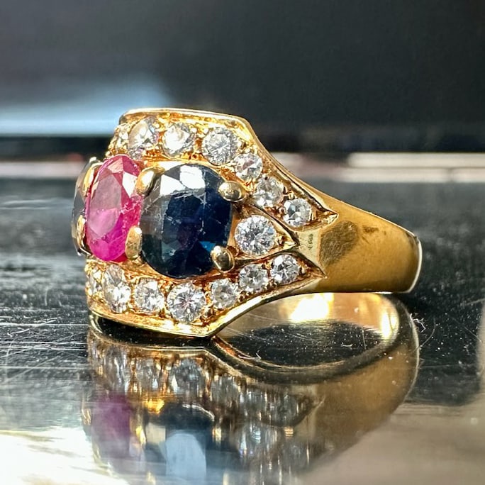 Beautiful 0.70ct Diamond Ruby and Sapphire 9.7gr Ring set on 18k solid gold: Beautiful 0.70ct Diamond Ruby and Sapphire 9.7gr Ring set on 18k solid gold 24 diamonds weighing 0.70ct 1 ruby mm6,6 x 5,4 2 sapphires mm6,6 x 5,4 each US 9 SKU: 113 weight: 9.7gr Our company's certif