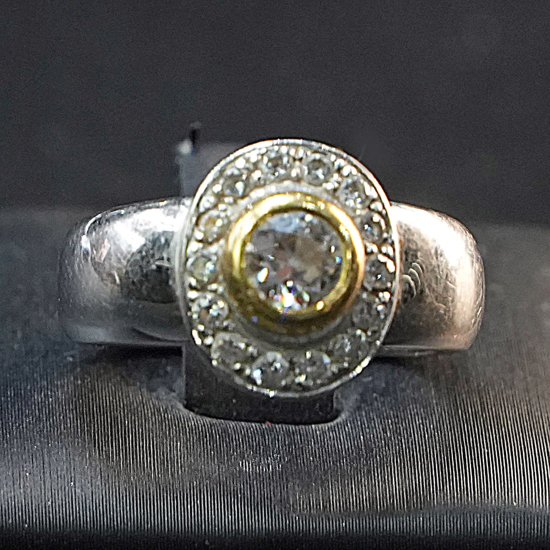 White and Yellow 18K Gold Ring with Antique Cut 0.40ct Diamond and Surrounding 0.28ct Accents, 6.94g: Elegant two-tone 18K gold ring featuring a striking antique-cut central diamond, complemented by a halo of smaller sparkling accent diamonds. This refined design balances classic sophistication with d
