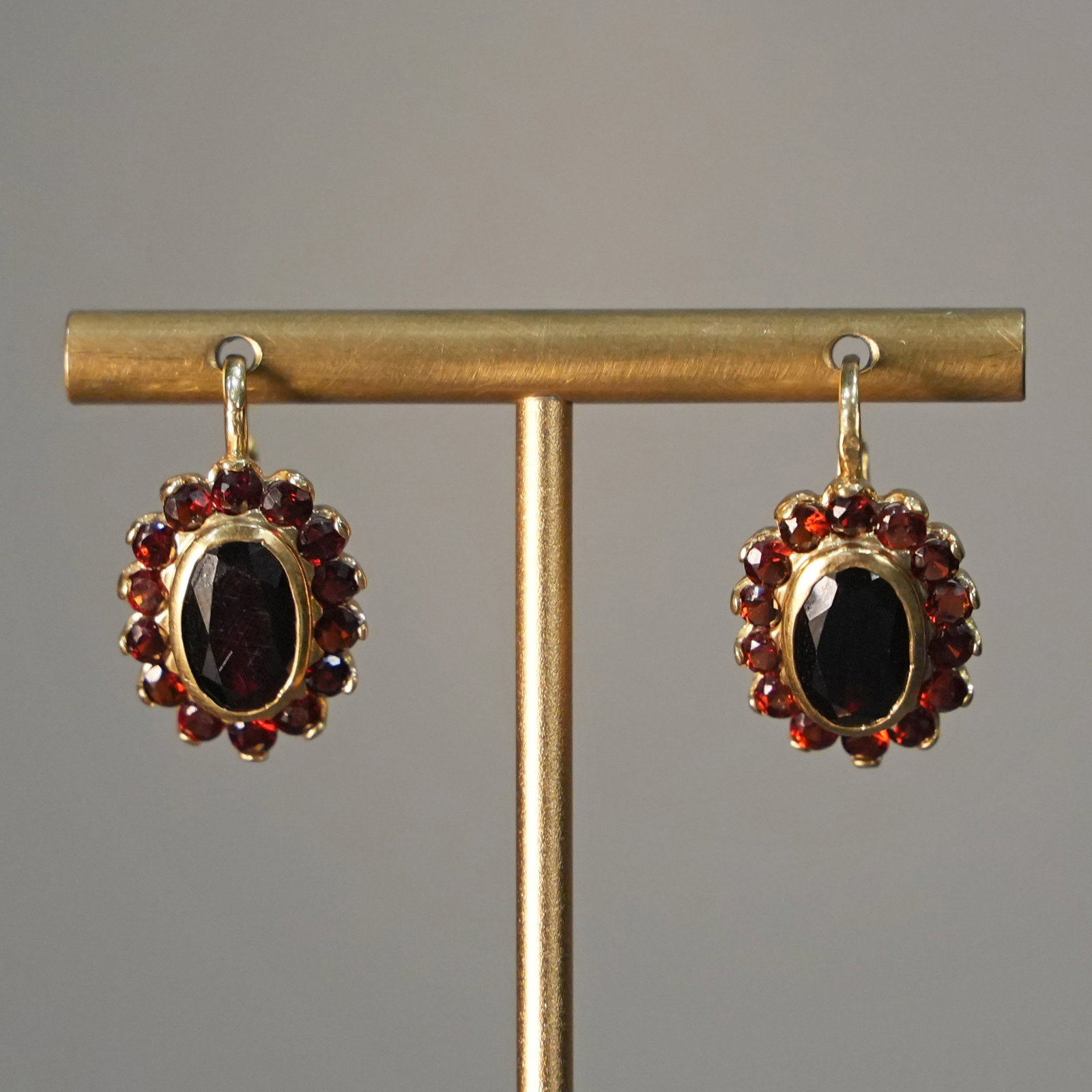 18K Yellow Gold Rosette Earrings with Garnets Surrounded by Citrines, Post Closure, 6.61 gr: Chic 18K yellow gold rosette earrings featuring a central garnet surrounded by a halo of sparkling citrines. Designed with a secure post closure, these earrings celebrate classic jewelry elegance whil