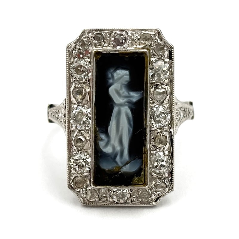 Antique ring, cameo, diamonds on platinum and gold; 8.48 gr.: With a magical and evocative aura, this 1930s-40s vintage cameo ring in 18 kt white gold mounts diamonds on platinum framing the handmaid's work carved on dark agate. Incredible workmanship for a uniq