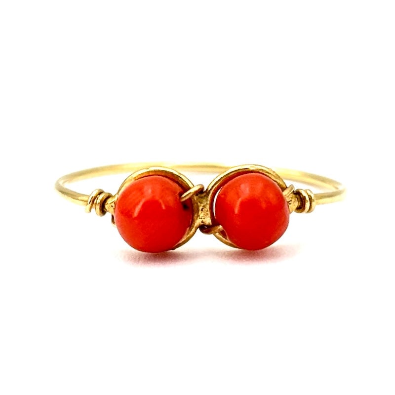 Coral balls and yellow gold wire ring; 0.93 g: Exquisite ring, made of 18kt yellow gold wire with central 0.5 cm diameter natural coral balls. Graceful, fresh and youthful jewelry. Our company's certification is available for free, upon request. I