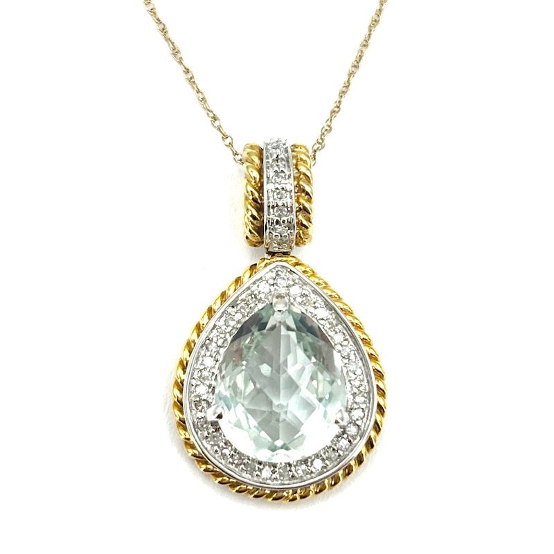 Aquamarine, diamond and two-tone gold drop pendant; 4.96 gr.: A celestial wonder from a marriage of styles! Aquamarine drop pendant surrounded by diamonds on white gold and yellow cord. The pendant includes a 45 cm 14 kt yellow gold chain. Scenic and unique, at 