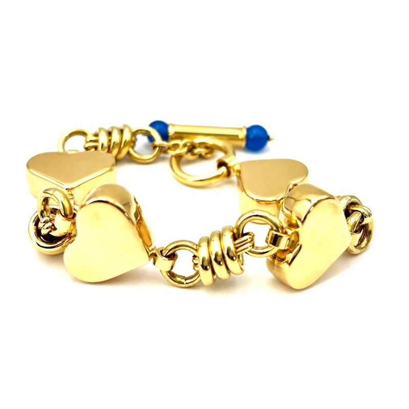 Yellow gold maxi hearts chain bracelet; 33.82 gr - 18 cm: A romantic and majestic 18 kt yellow gold, feminine, vexatious, maxi-heart chain bracelet with young movable clasp featuring round-cut blue agate cabochons. Reconditioned to new. Our company's certifi