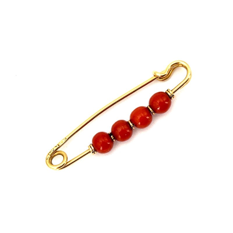 Vintage coral and yellow gold safety pin; 3 cm - 1.34 gr.: Vintage, safety pin-like brooch, classic elongated model in yellow gold, with micro boulle of natural red Mediterranean coral. 1960s-1970s era. The unmistakable style of yesteryear that will never fad