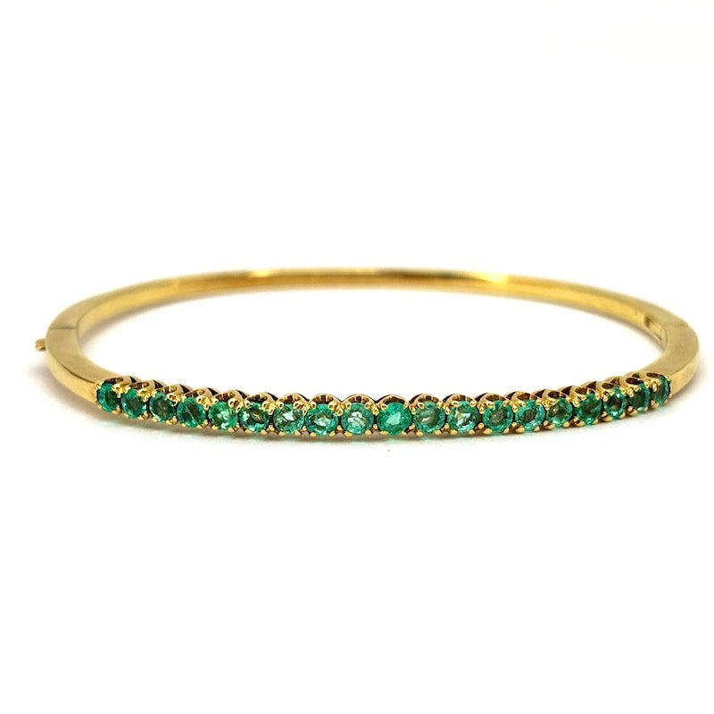 Yellow gold and emeralds rigid tennis bracelet; 12.36 gr.: Highly sought-after and timelessly inspired rigid bracelet! Rigid hoop tennis bracelet, 18 kt yellow gold, with riviere emeralds on the front. Crazy style for a very versatile and must-have occasional