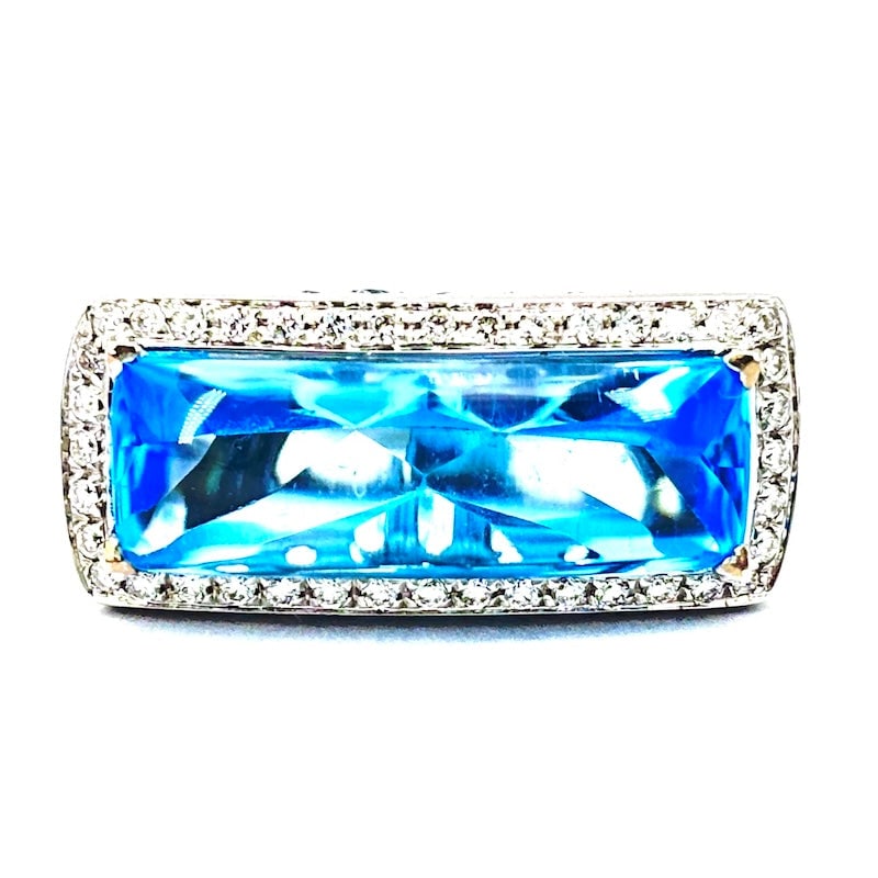 Blue topazes, diamonds and gold band ring; 17.8 gr.: Unusual and vibrant design, super contemporary and azure! Solid 18 kt white gold band ring with shaped blue topaz surrounded by brilliants and other blue topazes! A fashionable wonder! Our company's c
