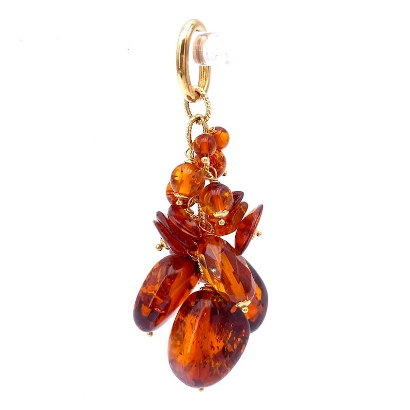 Amber cluster pendant, yellow gold; 8.64 gr.: Young jewelry with an ethno chic design! Cluster pendant of amber stones of various sizes, in 18 kt yellow gold. Our company's certification is available for free, upon request. If you wish to receive
