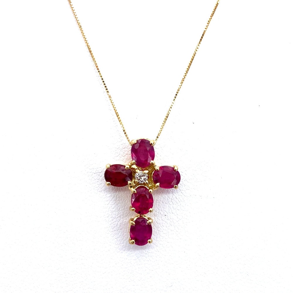 Cross pendant rubies, brilliant and yellow gold; 2.91 gr.: Powerful and linear elegance! Ruby cross pendant with central brilliant. The pendant includes a 44 cm 18 kt yellow gold Venetian chain. Our company's certification is available for free, upon request.