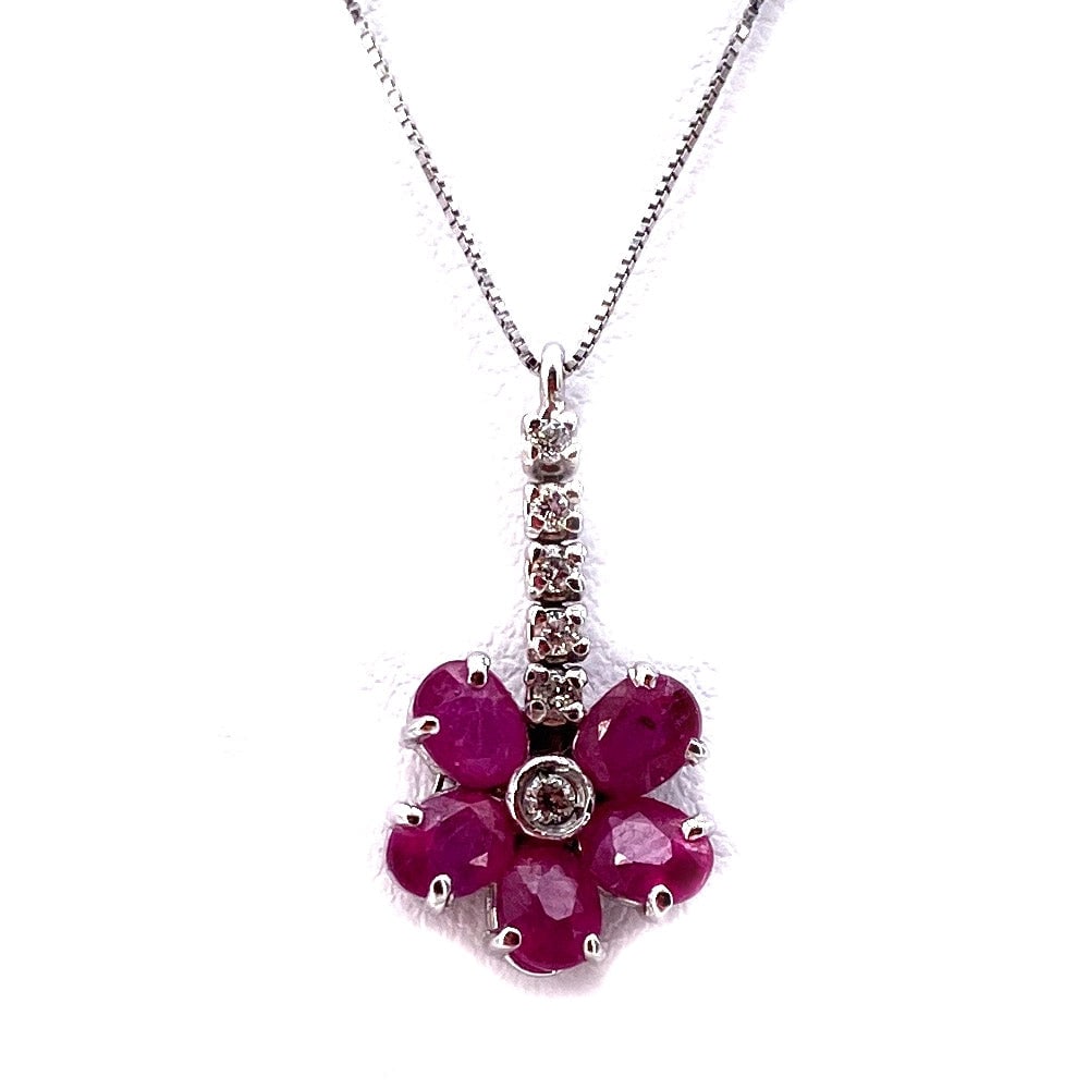Ruby flower pendant and mini match diamonds and gold; 2 gr.: A red delight! Flower pendant with ruby petals and with mini match of diamonds in white gold. The pendant includes a 44-cm 18-karat white gold Venetian chain. Our company's certification is available 