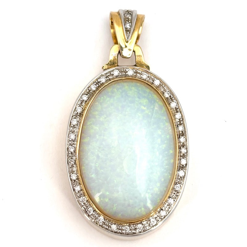 Maxi opal, diamond, and gold pendant; 17.08 g: Gorgeous and imposing maxi oval pendant in 18 kt two-tone gold with a stunning opal surrounded by diamonds. An unusual, opalescent, and unforgettable touch of distinctive femininity! Our company's cer