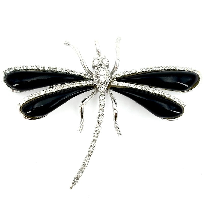 Dragonfly pendant, onyx, diamonds, and white gold; 11.13 g: Incredible design for this super contemporary dragonfly pendant admirably crafted in 18kt white gold, with shaped onyx wings and 0.60-0.70 ct of diamonds. Extremely precious, sinuously wavy, a truly c