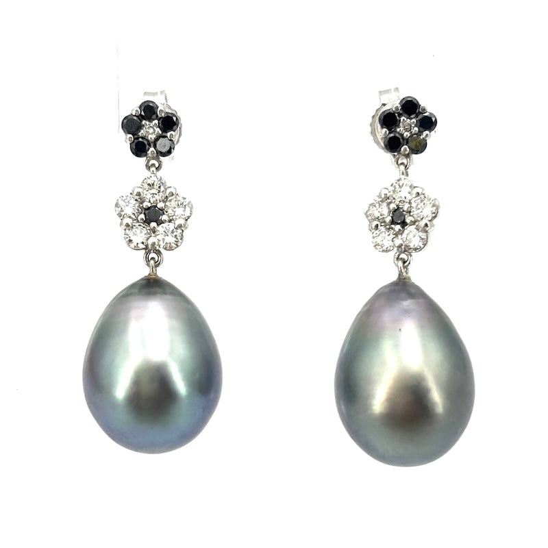 Tahitian pearl drop earrings with brilliant white and black daisies and gold. 8.05 g; 2.8 cm: Splendid white gold drop earrings with exclusive Tahitian grey pearls and black and white diamond daisies. A post and butterfly backing add an exquisite, highly prized, and exotic touch of class to yo