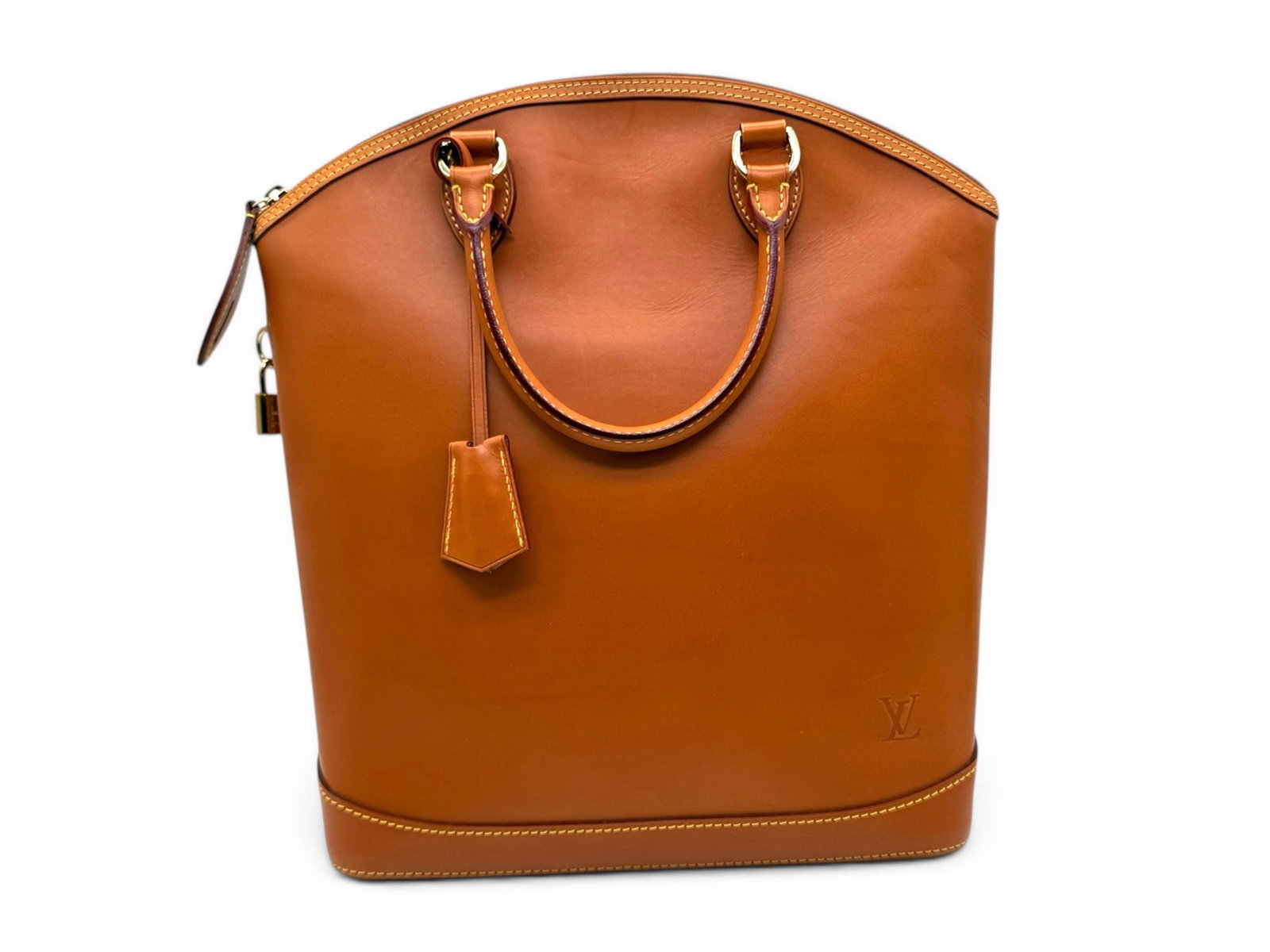 Louis Vuitton Lock It Vertical Nomad Bag, Cognac, Sophisticated and Timeless Tote: A refined Louis Vuitton Lock It Vertical Nomad bag crafted in rich leather, combining structured elegance with everyday functionality. Its warm Cognac tone and bold silhouette create a timeless luxury