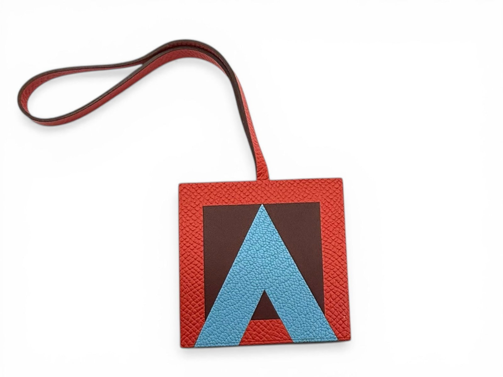 Hermes Lettre Au Carre A Key Holder, Red, Elegant and Iconic Charm: A distinctive Hermes Lettre Au Carre ?A? key holder crafted in refined leathers, combining elegance and iconic design in a compact luxury accessory. The bold red tone enhances its sophisticated charac