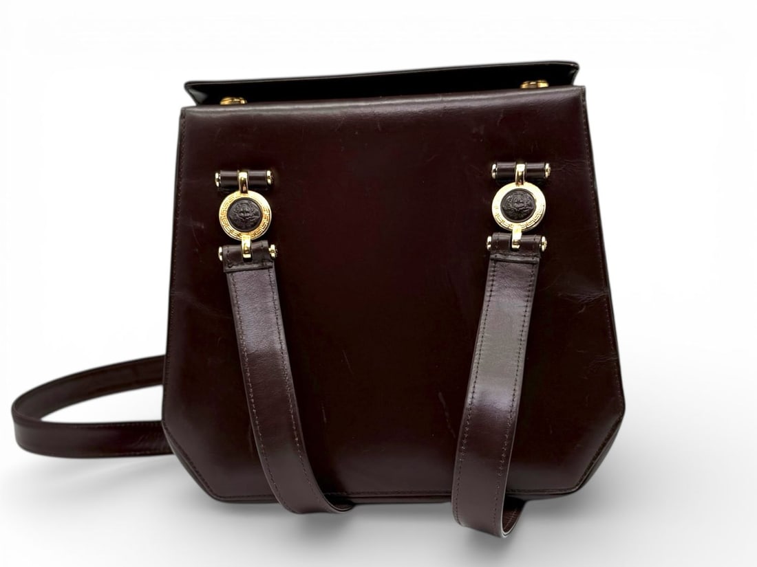 Versace Brown Leather Shoulder Bag Gold Hardware - Glamorous & Bold: Luxurious Versace handbag crafted from rich brown leather, embodying a strong and confident style. Embellished with striking gold hardware, this accessory exudes the Maison?s signature opulence. Prese