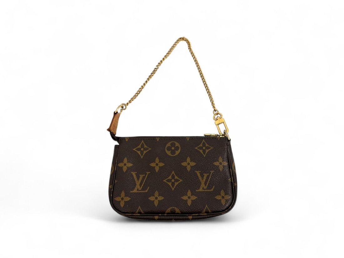 Louis Vuitton Mini Accessoires Monogram Canvas - Iconic & Collectible: Iconic Louis Vuitton Mini Accessoires crafted from the timeless Monogram canvas with natural cowhide details. This "bijou" of a bag, finished with gold hardware, captures the quintessential charm and 
