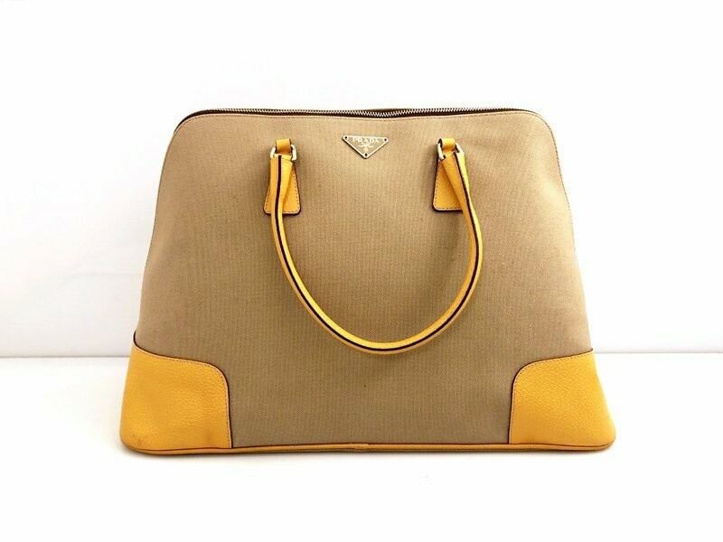 Prada Promenade XL Yellow Leather & Canvas Handbag - Radiant & Exclusive: Magnificent Prada Promenade XL handbag featuring a striking combination of yellow leather and canvas. This substantial piece, accented with rich gold hardware, offers a radiant and commanding presence