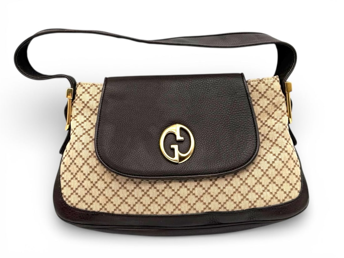 Gucci Brown Monogram GG Shoulder Bag - Timeless Elegance: Classic Gucci shoulder bag featuring the iconic GG monogram canvas with refined brown leather trim. Adorned with polished gold hardware, this piece reflects the understated luxury and heritage of the 