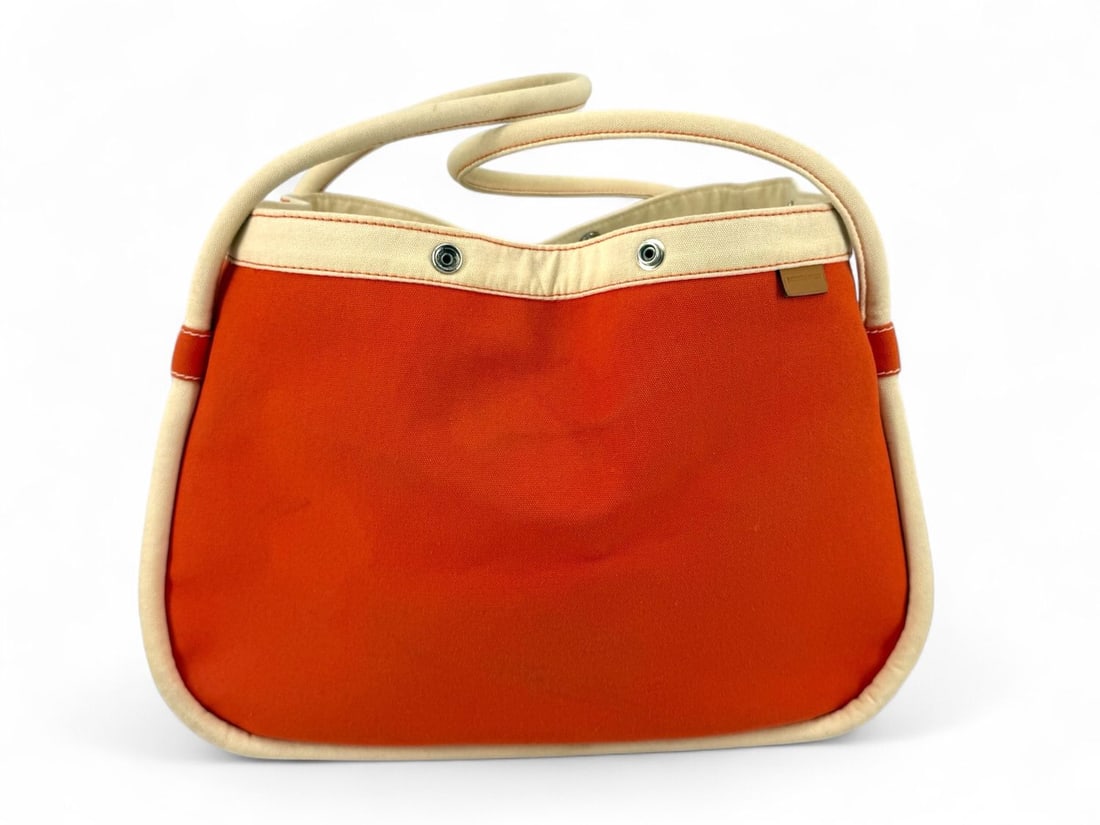 Hermes Lindy 35 Orange & Cream Canvas - Avant-Garde Luxury: The legendary Hermes Lindy 35, celebrated for its unique, avant-garde silhouette and exceptional craftsmanship. This rare version is crafted from durable canvas in a vibrant Orange and Cream palette, 