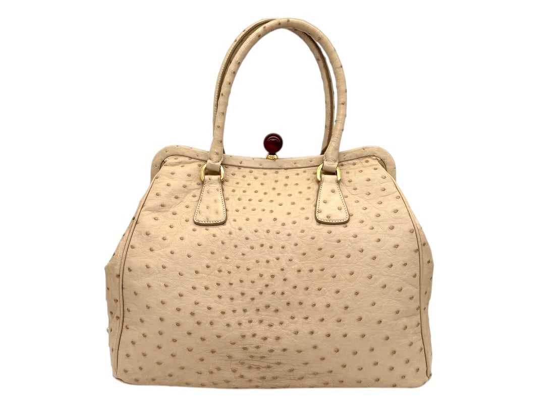 Prada Creme Ostrich Leather Handbag - Exotic & Absolute Masterpiece: A breathtaking Prada handbag masterfully crafted from precious creme Ostrich leather, a material of extreme rarity and prestige. Highlighted by opulent gold hardware, its unique textured appearance an