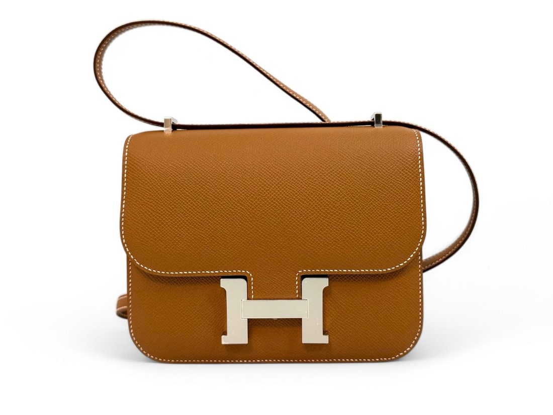 Hermes Mini Constance 18 Gold Epsom - Exquisite & Coveted Jewel: The spectacular Hermes Mini Constance 18, expertly crafted from durable and structured Gold Epsom leather. Featuring the signature oversized "H" clasp in Palladium and an integrated mirror, this bag i