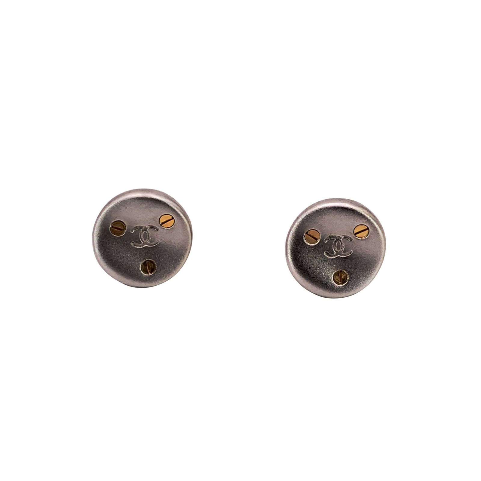 Chanel Vintage Metal Earrings CC: A striking pair of Chanel vintage earrings dating back to 1998, these clip-on beauties perfectly capture the bold yet refined spirit of the House. Crafted in silver-tone metal, they feature a round si