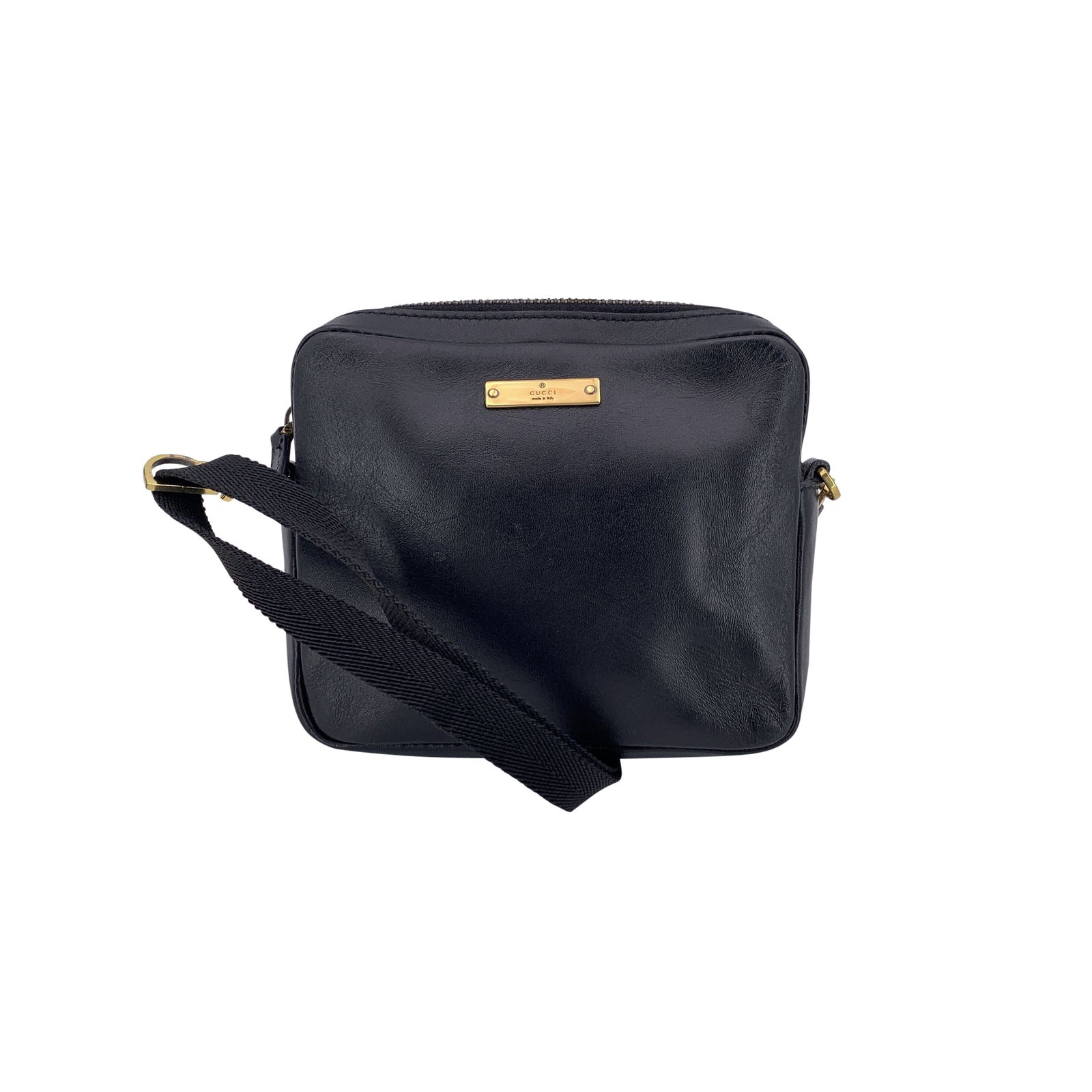 Gucci Leather Crossbody Bag: This Gucci Mini Crossbody Bag is crafted in sleek black leather, featuring a gold-tone 'Gucci - Made in Italy' tab on the front. The top zipper opens to a monogram fabric-lined interior with one side