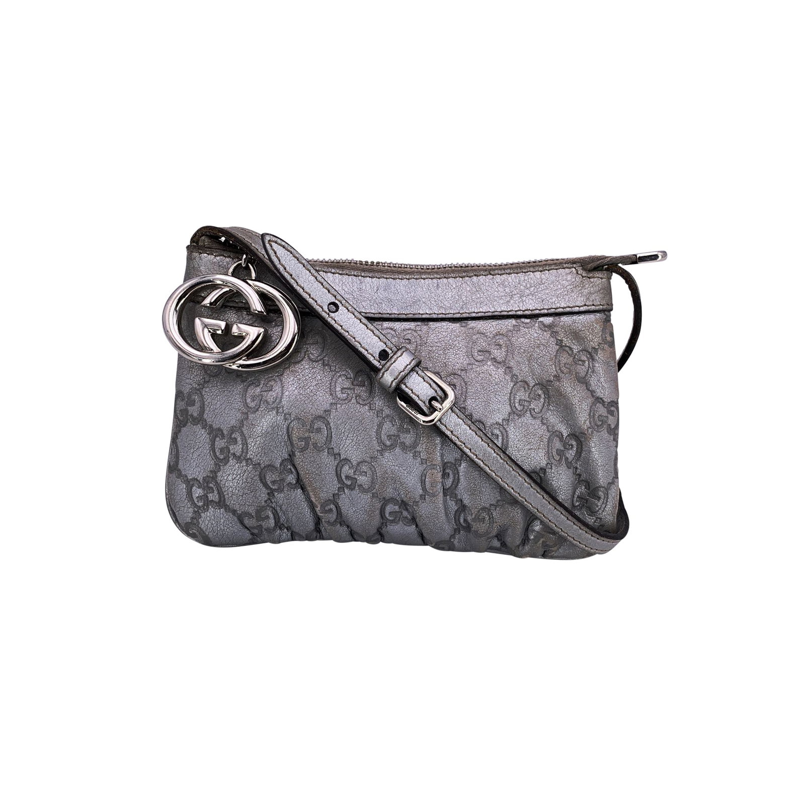 Gucci Cloth Crossbody Bag: This Gucci metallic silver Guccissima leather mini crossbody bag is a chic and modern accessory crafted in the brand's signature embossed monogram leather. The metallic silver finish is paired with