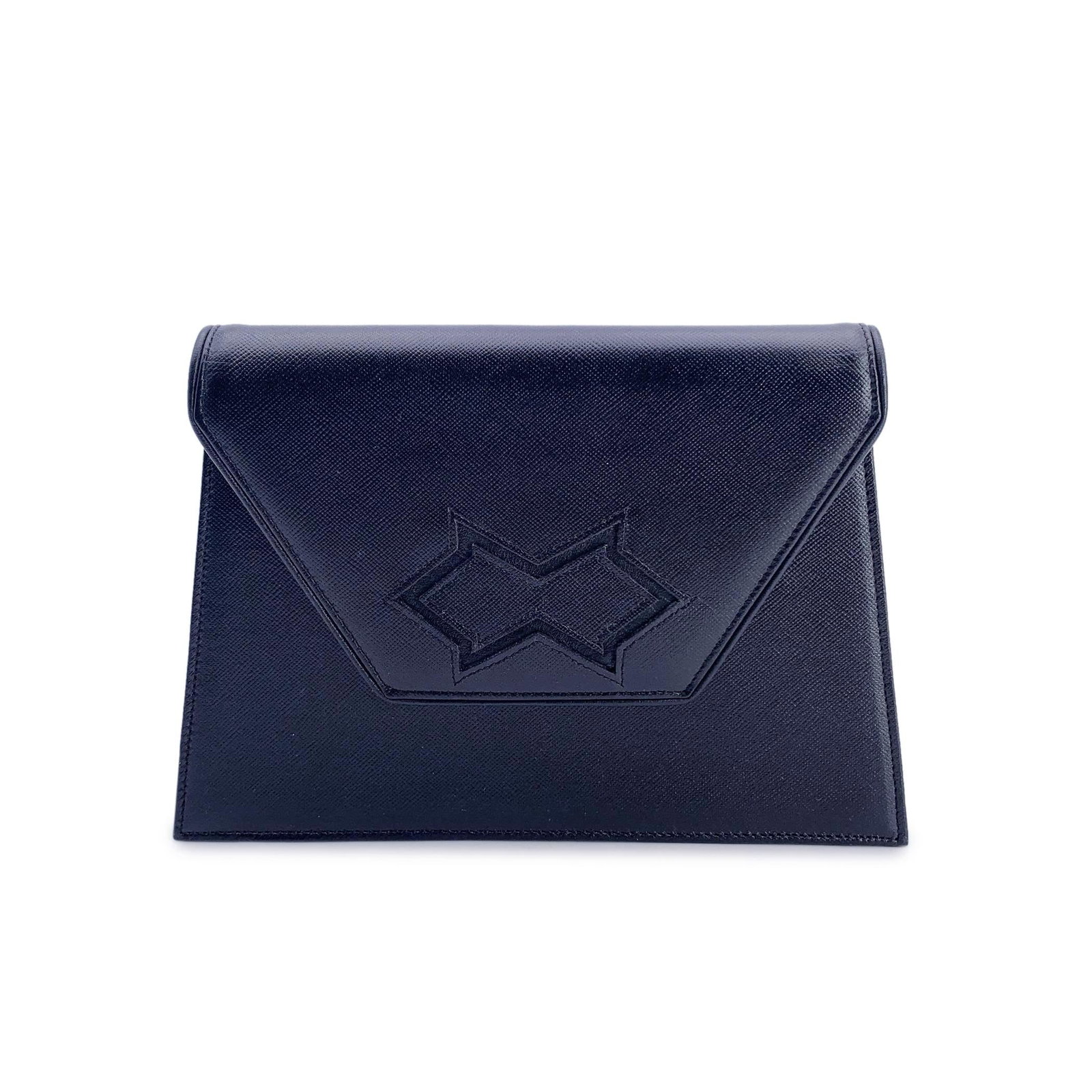 Yves Saint Laurent Vintage Leather Clutch Bag: Yves Saint Laurent vintage clutch bag, crafted in black leather. Trapeze-shaped. It features a flap with magnetic button closure on the front. Beige fabric lining with YSL logos. 1 side zip pocket ins
