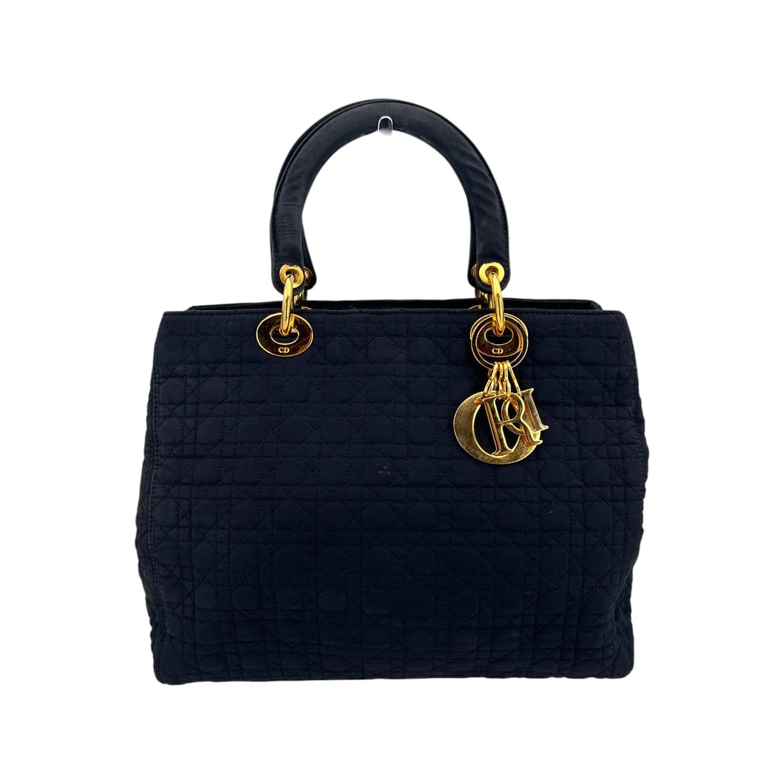Dior Vintage Cloth Handbag Lady Dior: Embrace a piece of fashion history with this Christian Dior Vintage Black Cannage Quilted Fabric Lady Dior Tote Bag. Hailing from the 1990s, this medium-sized masterpiece is a testament to the timeles
