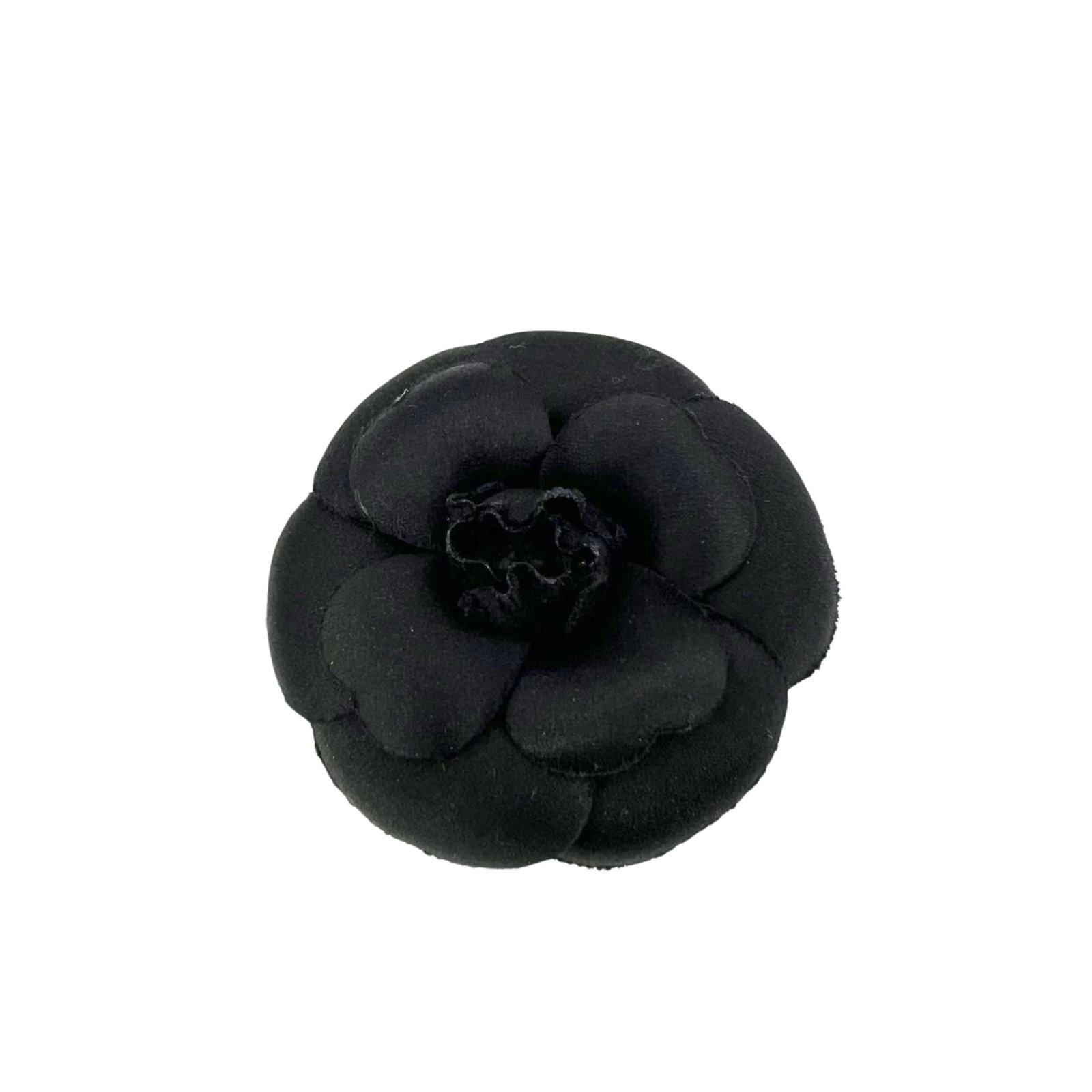 Chanel Vintage Cloth Brooch Camelia: Embodying the essence of 1990s Parisian chic, this vintage Chanel Camelia brooch is a true collector's gem. Handcrafted in Italy from luxurious black satin cloth, this iconic floral accessory represen
