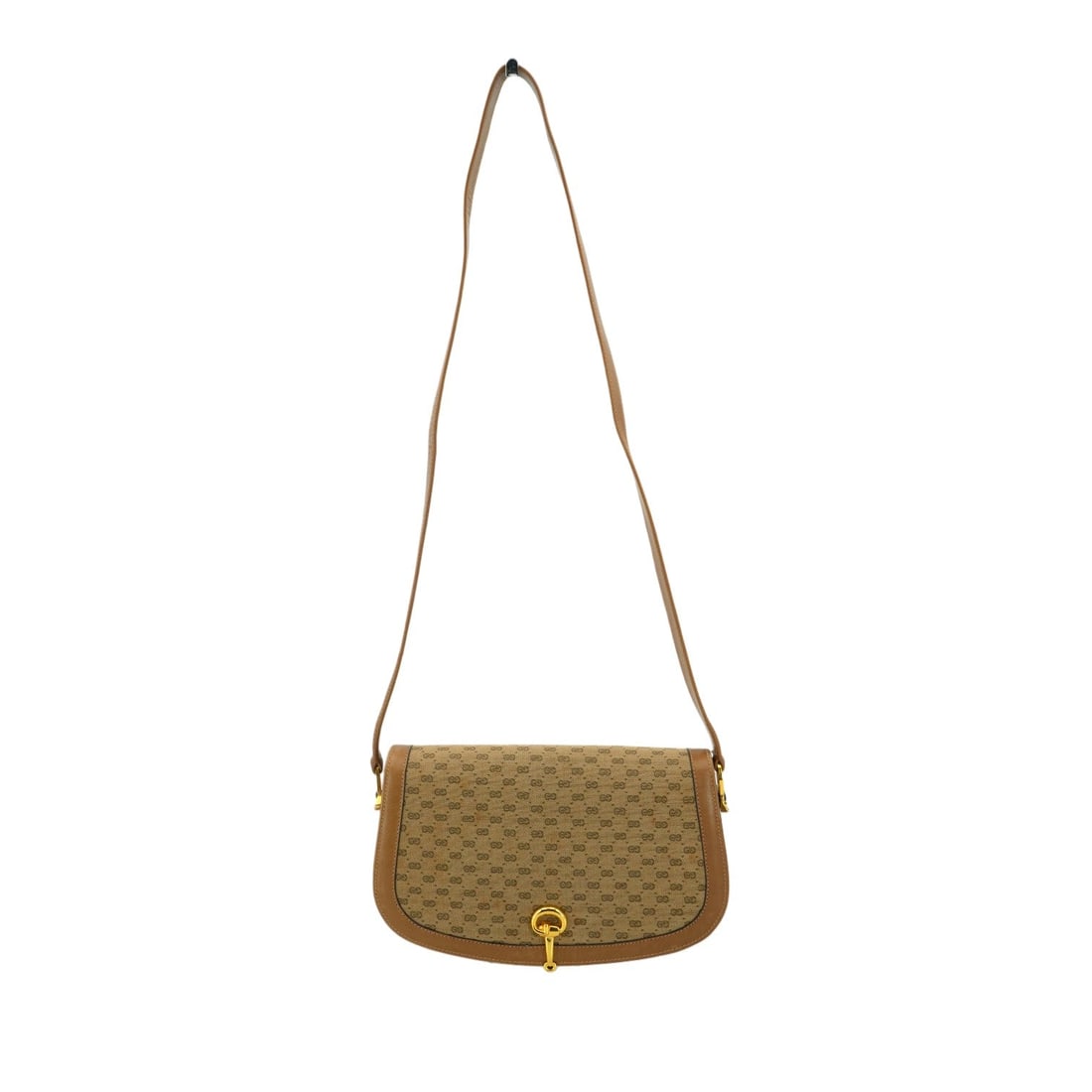 Gucci Vintage Cloth Shoulder Bag Horsebit: Transport yourself back to the 1970s with this exquisite Gucci shoulder bag, a quintessential piece of Italian luxury. Crafted from durable beige Micro GG monogram canvas and leather, this small-sized