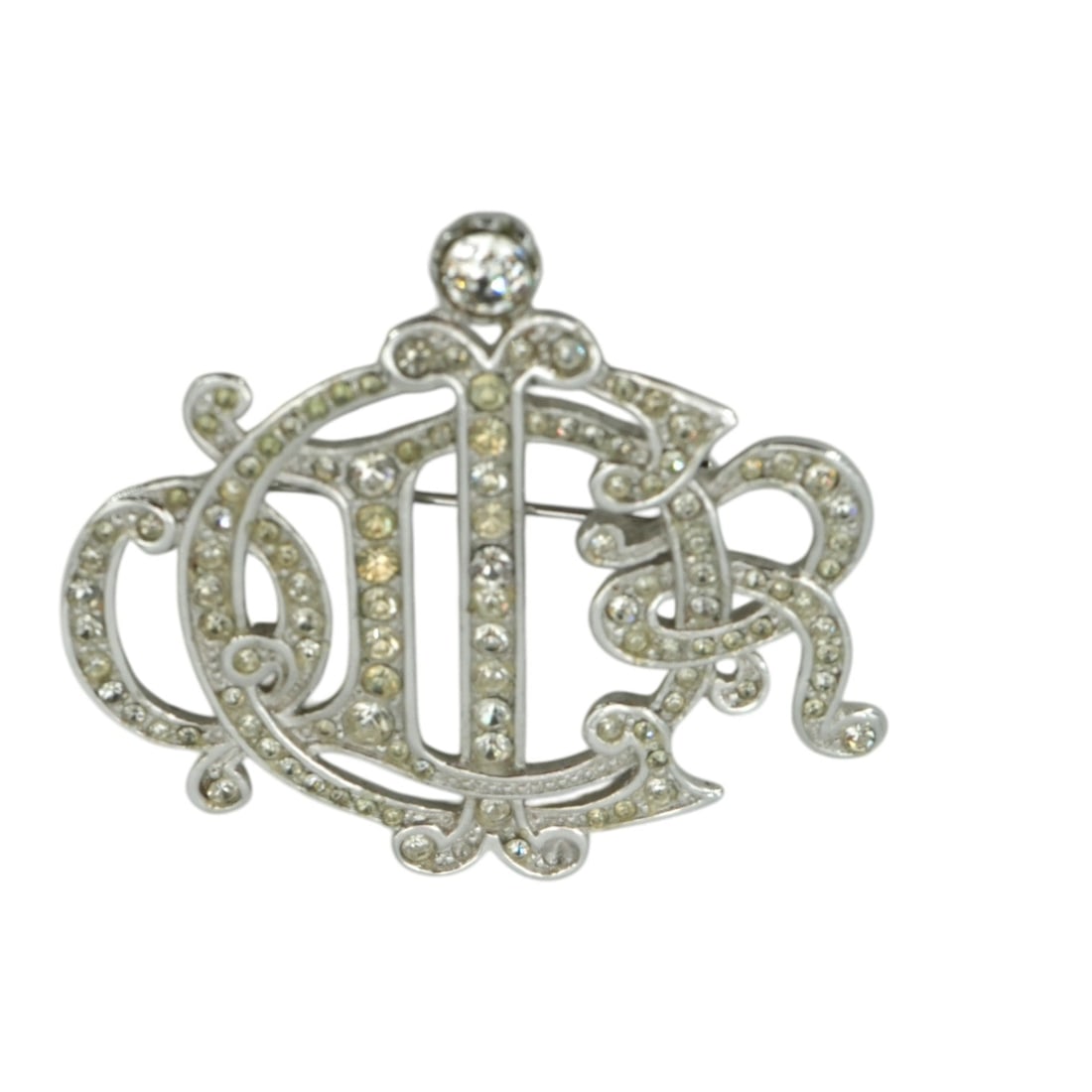 Dior Vintage Metal Brooch Monogram: Step into the elegance of the 1980s with this exquisite Christian Dior vintage monogram brooch. A true piece of fashion history, this stunning accessory was meticulously crafted in Germany between 198
