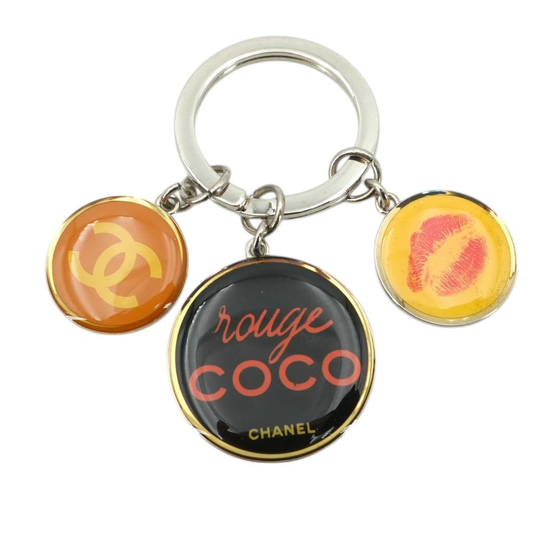 Chanel Other Accessory Coco Rouge: Elevate your daily essentials with this exquisite Chanel Silver Metal Rouge Coco Charm Key Chain, a piece that captures the playful yet sophisticated spirit of the Maison. This small-sized accessory f