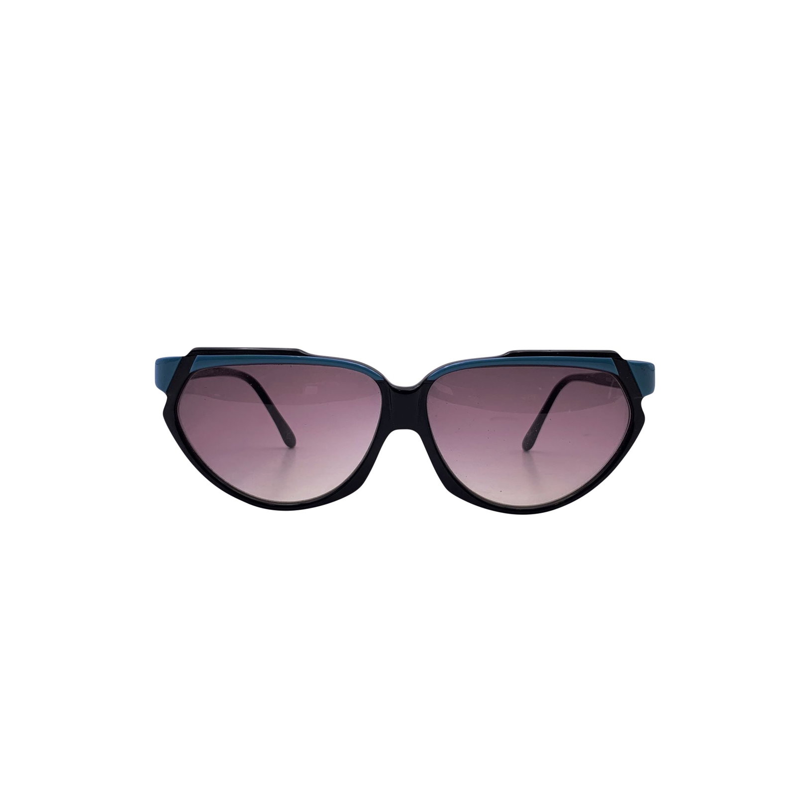 Jean-louis Scherrer Vintage Plastic Sunglasses: These Jean Louis Scherrer vintage cat-eye sunglasses are a striking example of 1980s French glamour, where bold shapes and vivid accents defined the era. Crafted in France, the frame is a deep black t