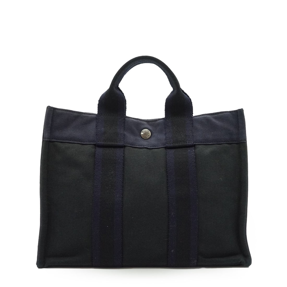 Hermes Vintage Cloth Handbag Fourre-Tout: Step back into the late 90s with this iconic Hermes Fourre-Tout, a model that redefined functional luxury for the modern woman. Meticulously crafted in France from durable navy blue and black canvas, 