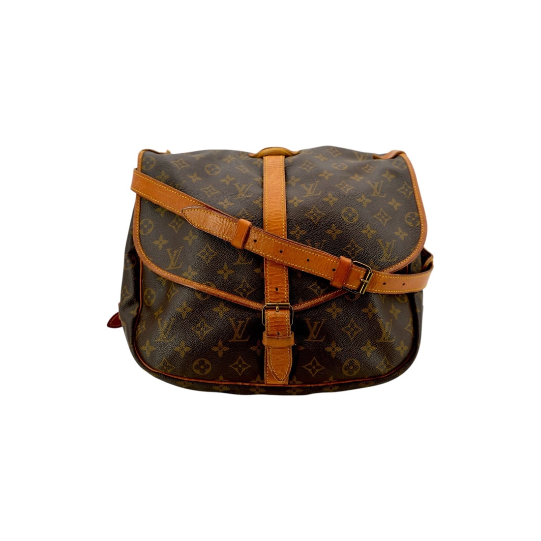 Louis Vuitton Vintage Cloth Crossbody Bag Saumur: Step into the world of equestrian-inspired elegance with the Louis Vuitton Saumur, a medium-sized crossbody bag that remains a cornerstone of vintage luxury. Expertly crafted in France during the 1990
