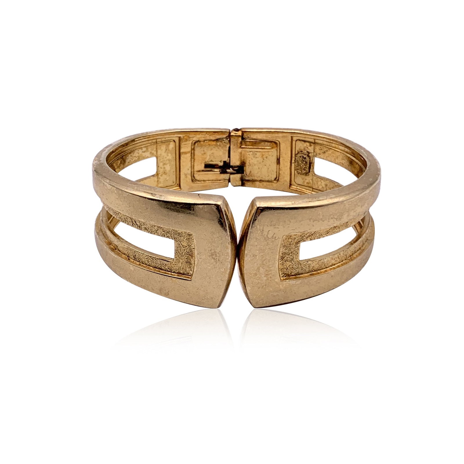 DIOR VINTAGE METAL BRACELET NOT APPLICABLE: Transport yourself to 1990s France with this exquisite Christian Dior vintage gold metal rigid clamper bracelet. This piece is a testament to the bold elegance of the decade, featuring a sleek cuff de
