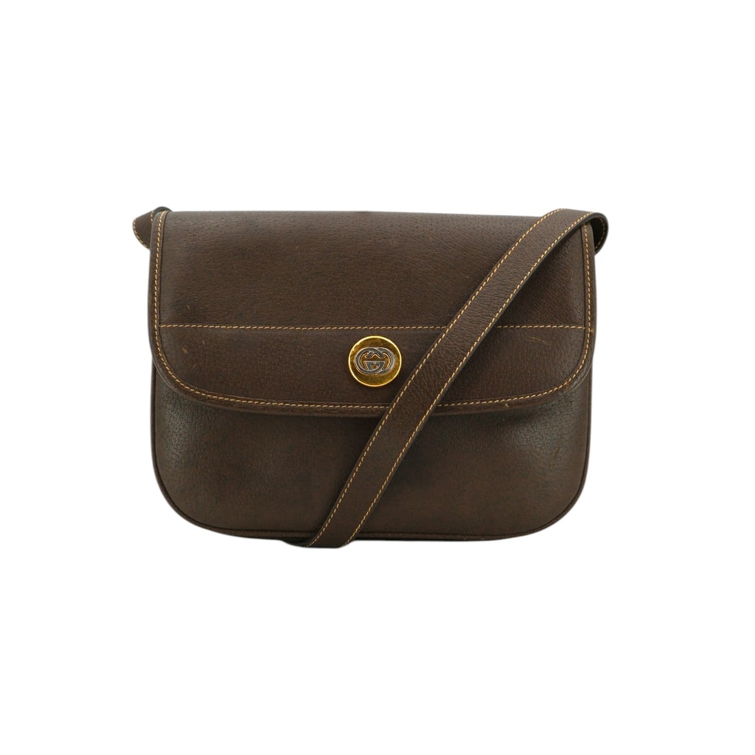 GUCCI VINTAGE LEATHER CROSSBODY BAG GG LOGO: Embrace the timeless allure of the 1980s with this Gucci Vintage Crossbody Bag, a quintessential piece of Italian craftsmanship. This medium-sized treasure is elegantly rendered in rich brown leather,